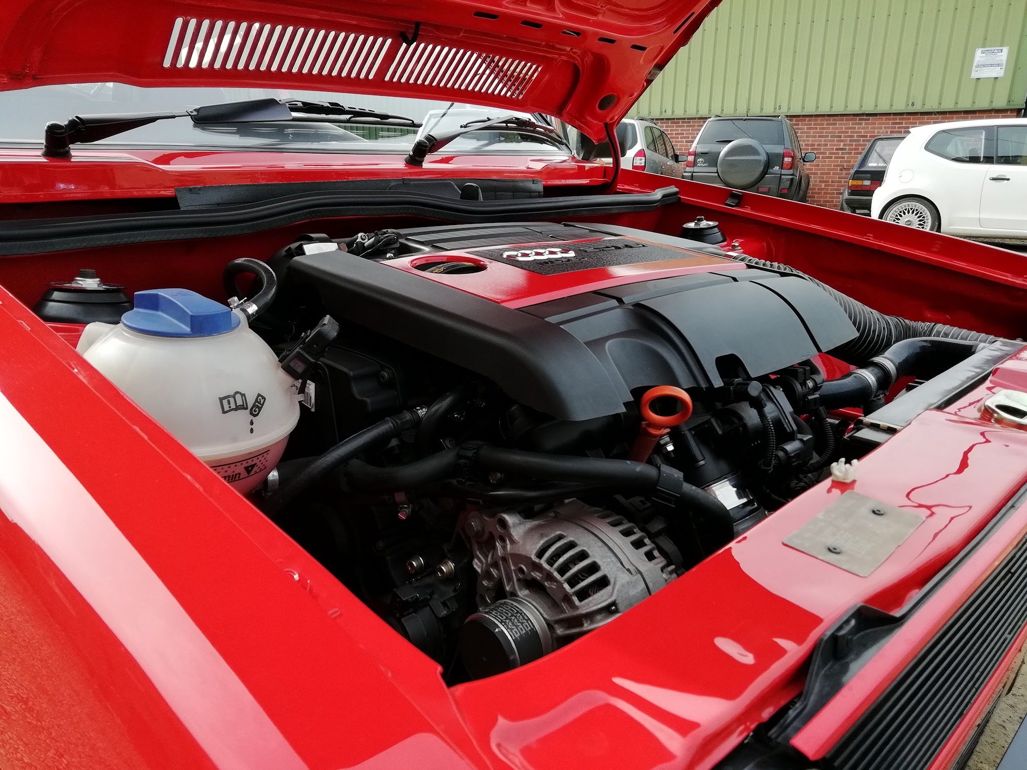 Red Mk1 Golf with the bonnet up and a modern engine fitted