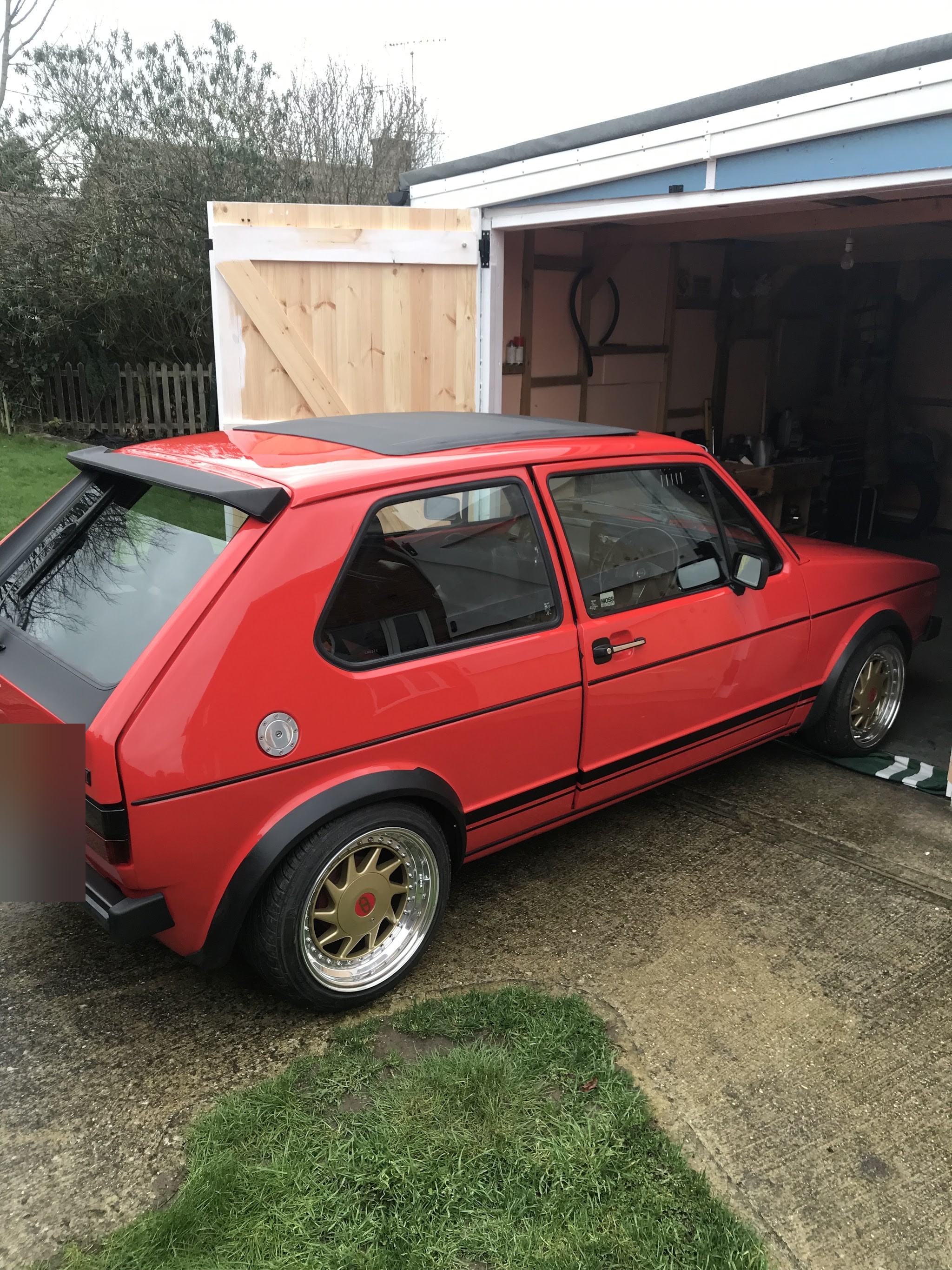 Red Mk1 GTI three-door on a driveway