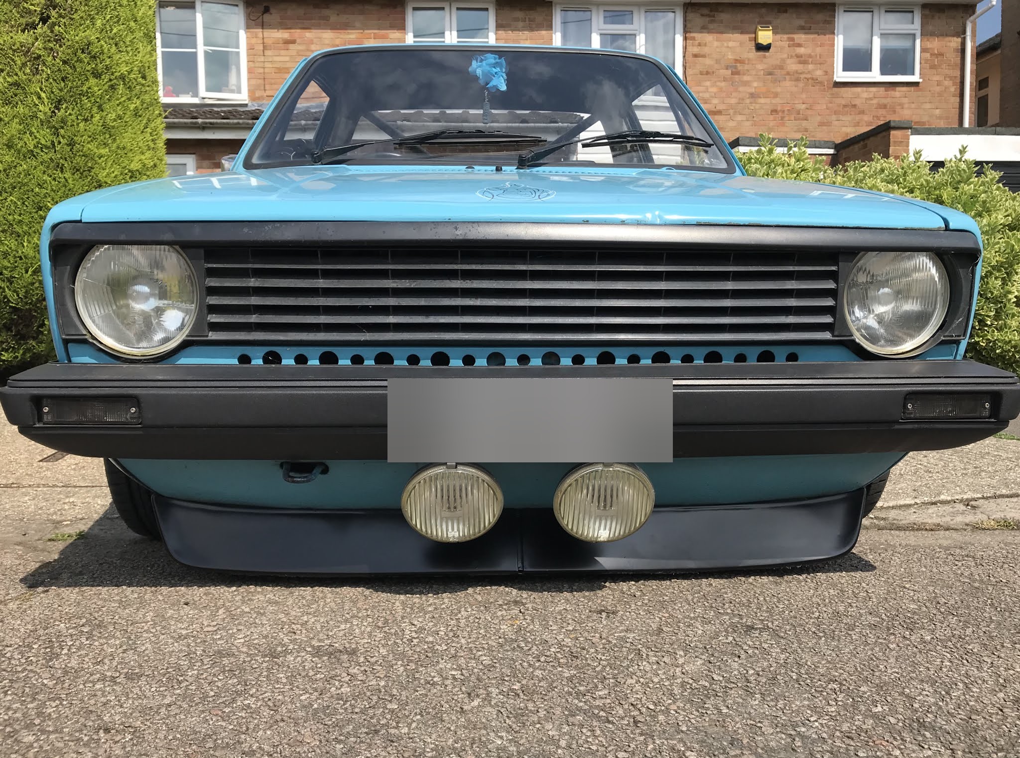 Light blue Mk1 Caddy pick-up from the front, with spot lamps