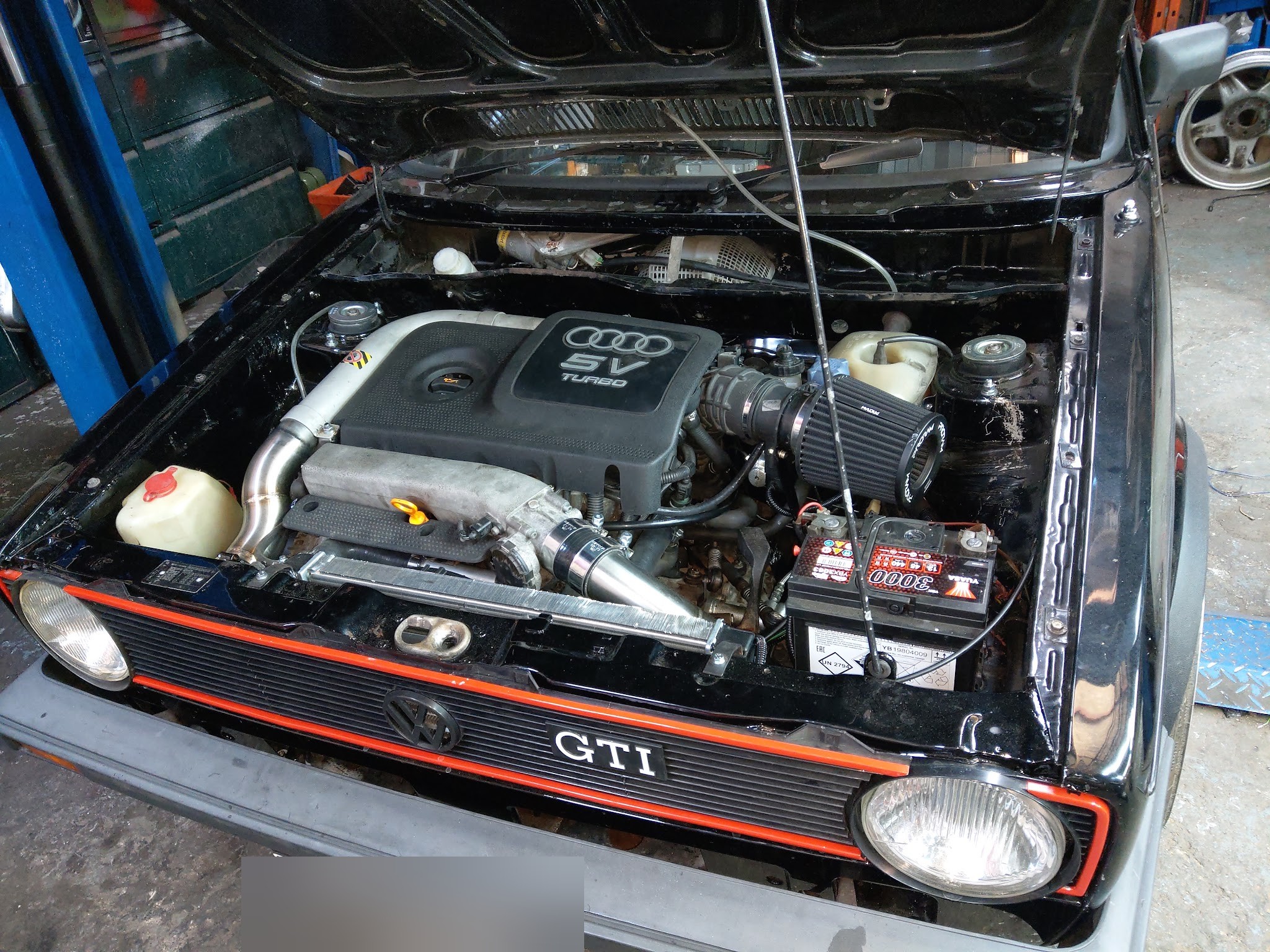 Black Mk1 GTI with a 20v turbo engine fitted behind the red-trimmed grille