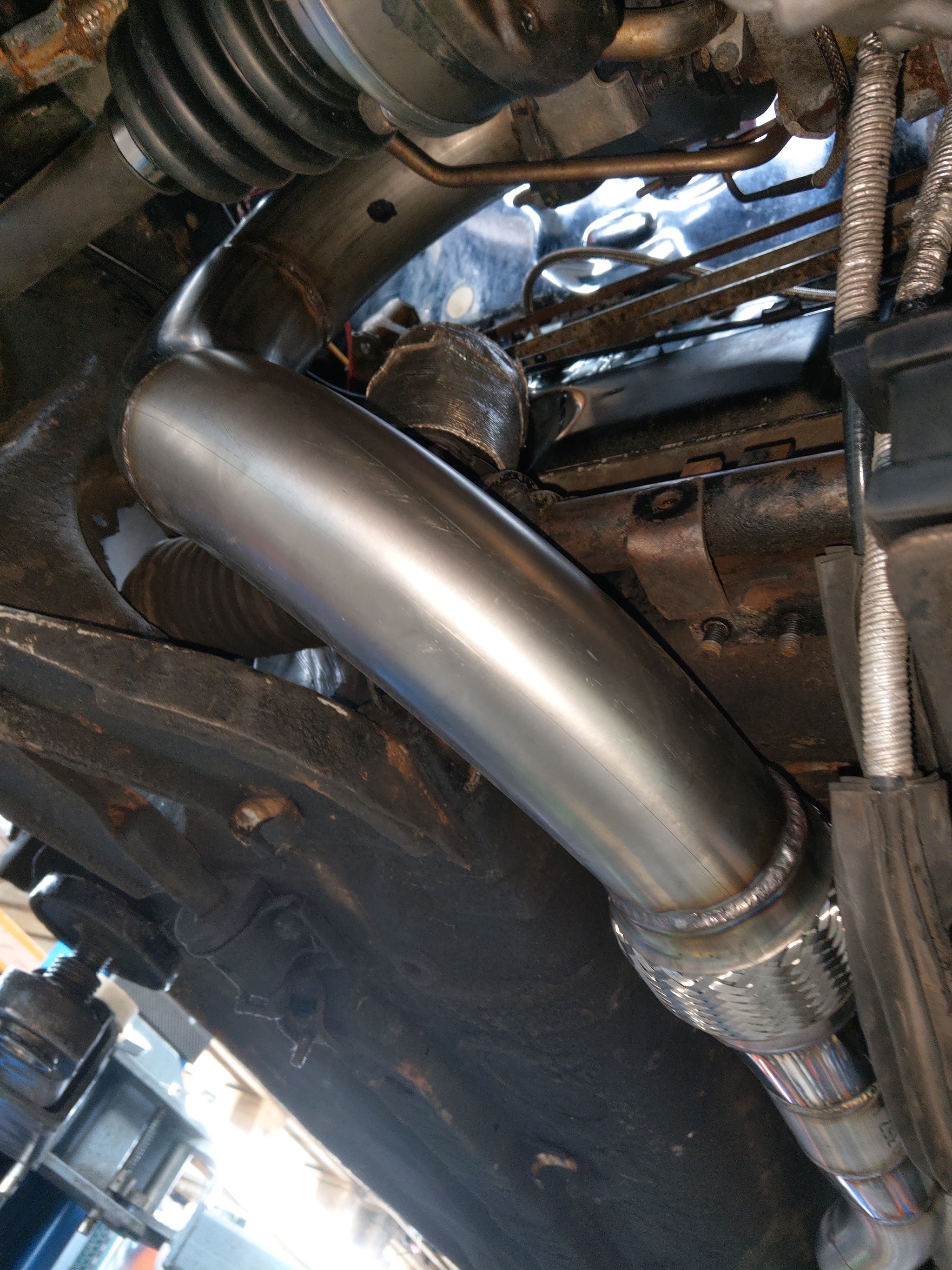 Looking up at new stainless exhaust pipework under a Mk1