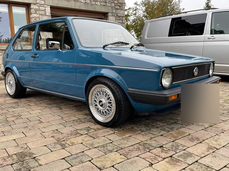 Blue Mk1 Golf on a cobbled yard