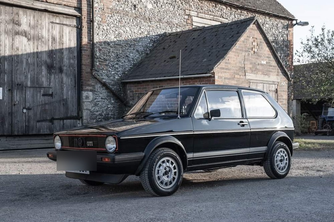 Black Mk1 GTI by a stone barn